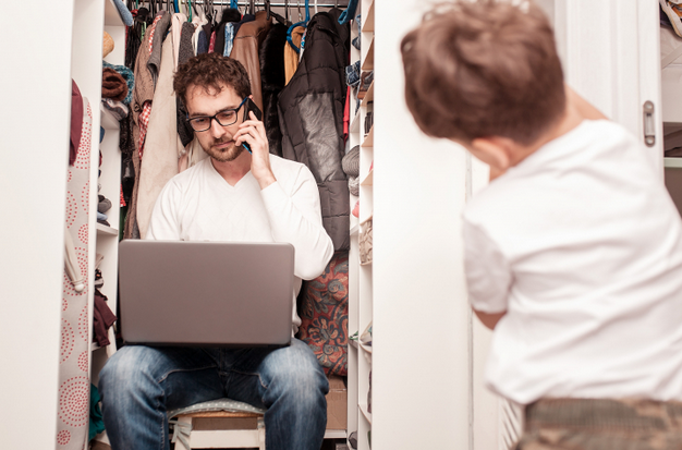 Man talking in the phone in a wardrobe