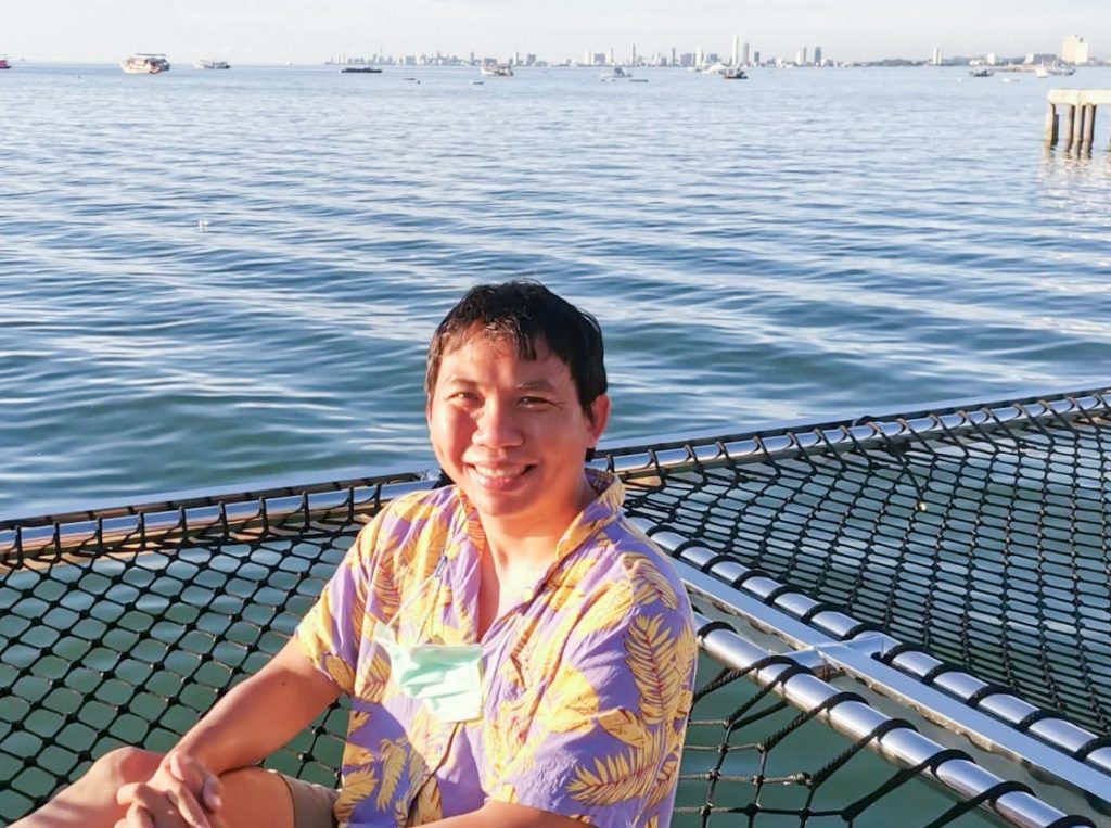 Man sitting by water